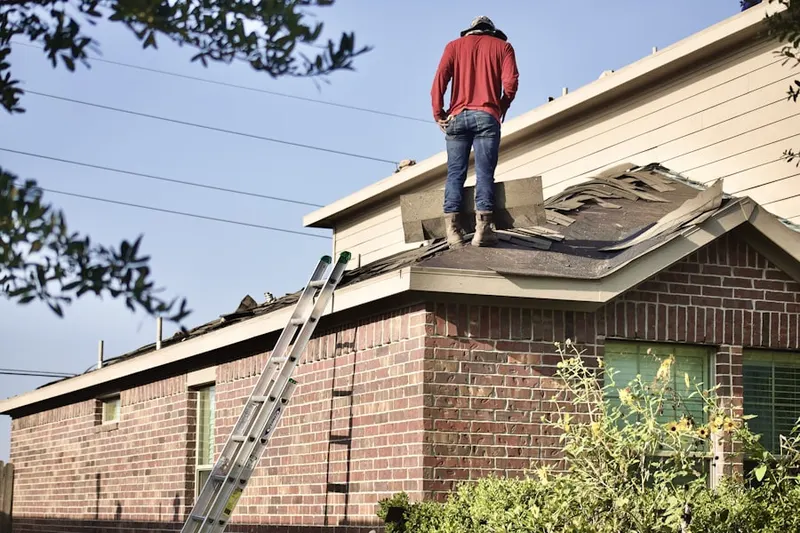Professional roofer working on a residential roof in Terrell